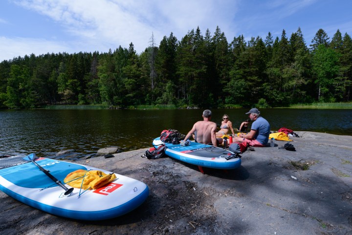 a group of people riding on the back of a boat in the water