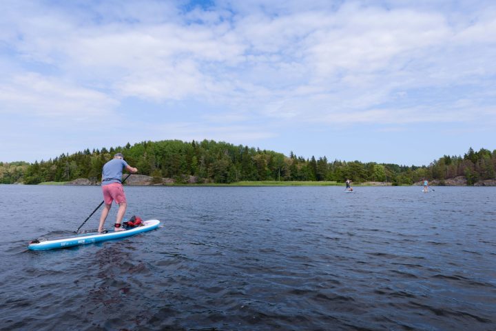 a person riding on the back of a boat in a body of water