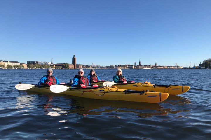 a group of people in a small boat in a body of water